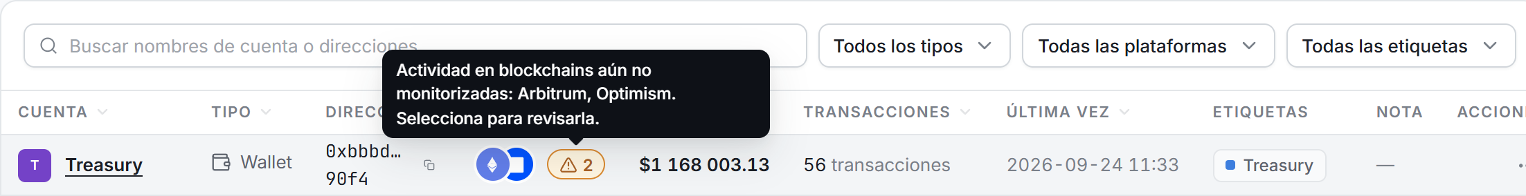 Una fila de cuenta en la página Cuentas con el indicador ámbar de actividad no monitorizada detrás de sus logotipos de plataforma, y su tooltip con los nombres de las blockchains